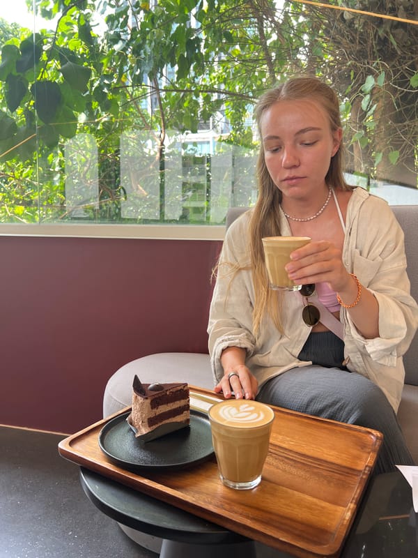 Woman pours coffee at Bangkok cafe during morning hours