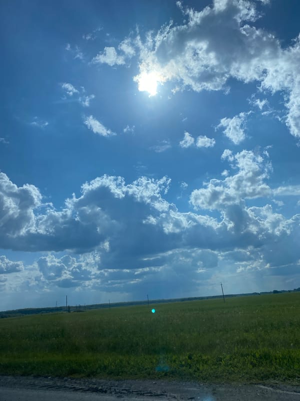 Dramatic skies over green field captured in Tyumen