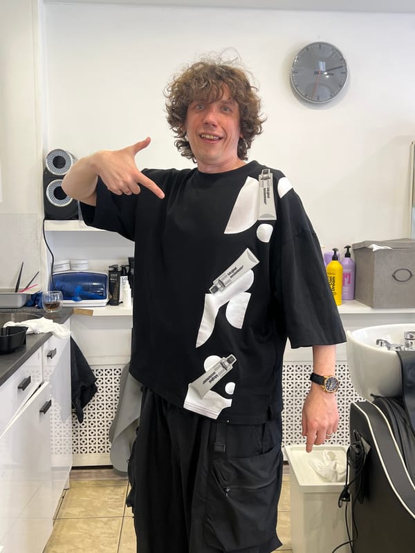 Man displays hair color products on shirt in Saint Petersburg