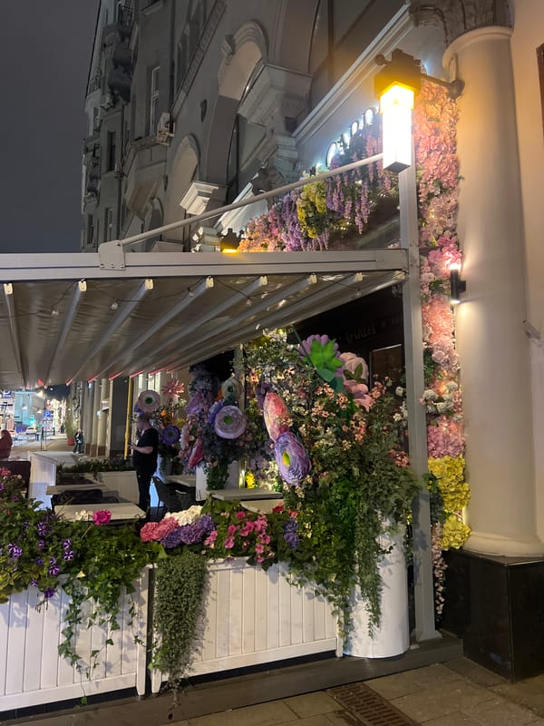 Moscow evening scenes show illuminated architecture, decorated restaurant entrance