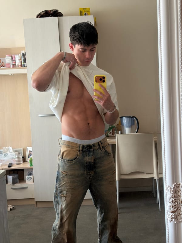 Young man takes mirror selfies with yellow phone in Sofia