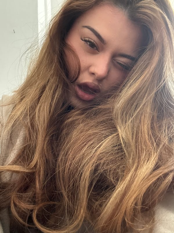 Woman takes playful selfies in Bulgarian office space