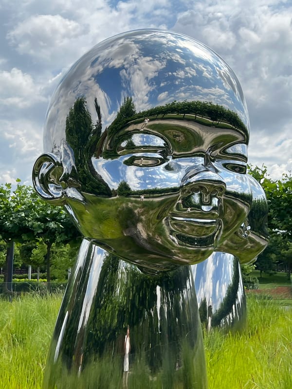 Chrome sculptures of baby heads and figures in Krasnodar park