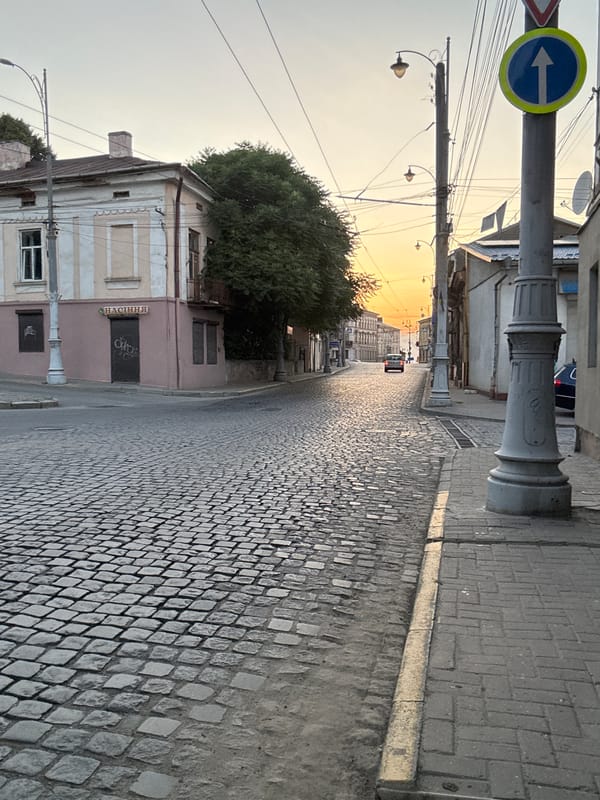 Chernivtsi cobblestone streets and rising moon at golden hour