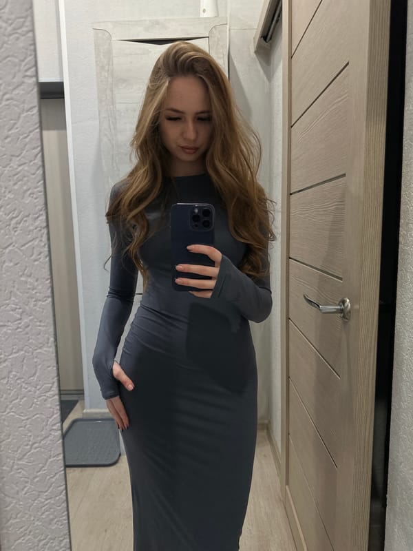 Woman Takes Mirror Selfie in Gray Dress