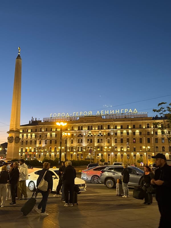 Palace Square and Hero City signage glow at Saint Petersburg dusk