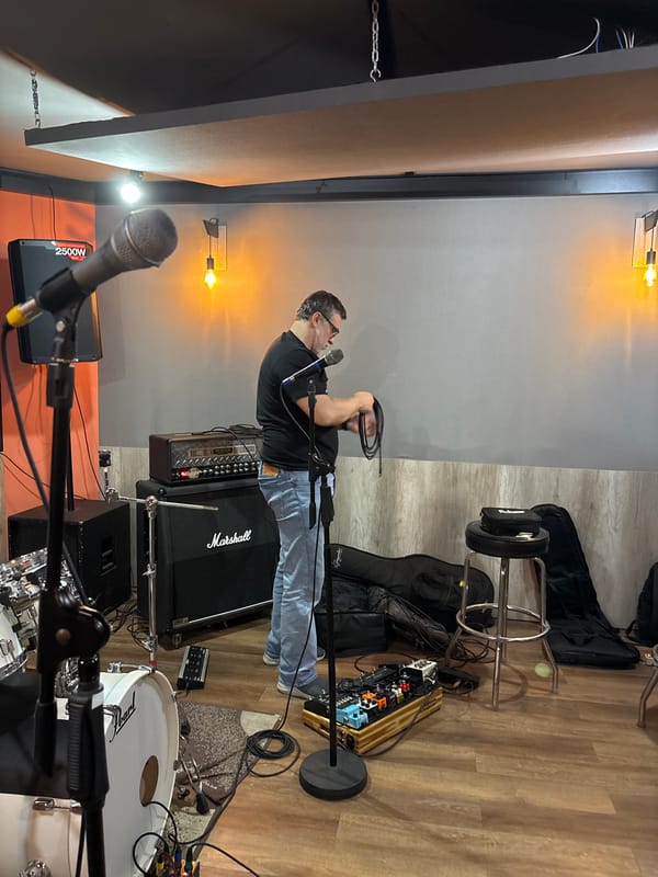 Musicians set up for band practice in São Paulo studio