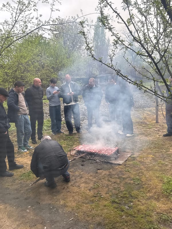 Men gather for outdoor barbecue in Kartubani, Georgia