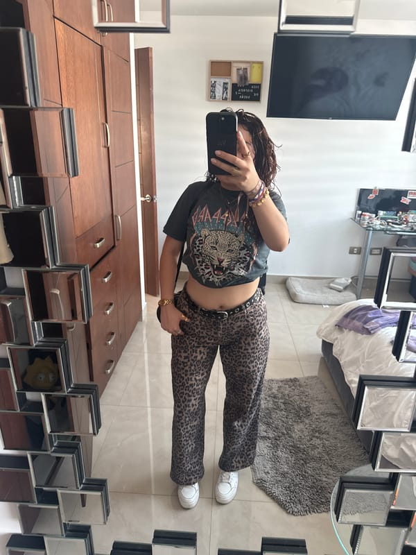 Person takes mirror selfie in leopard print outfit