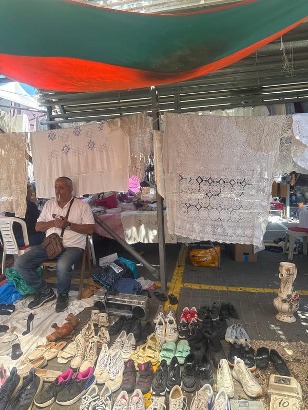 Vendor operates jewelry stall at Tel Aviv outdoor market