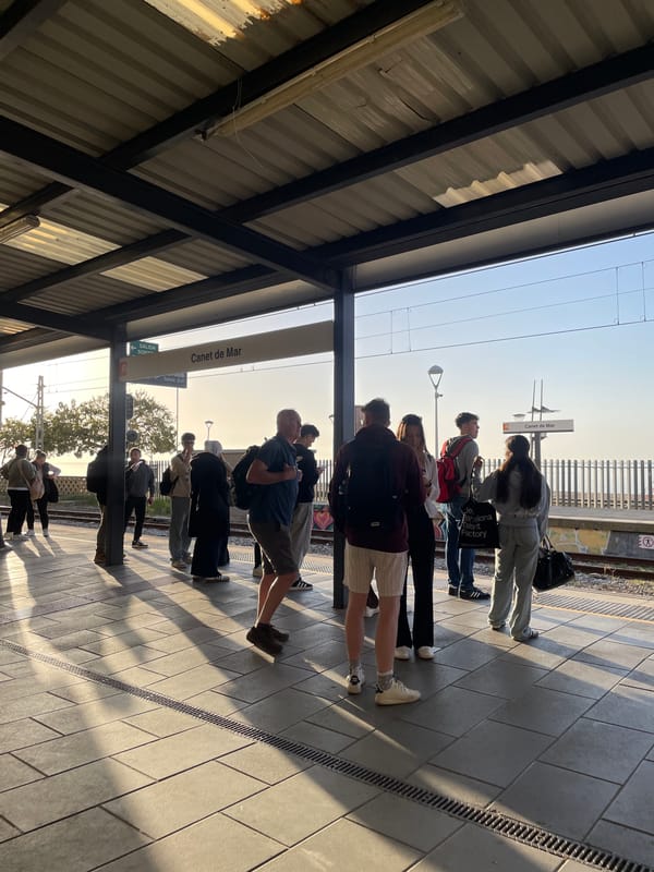 Morning commuters wait at Canet de Mar train station
