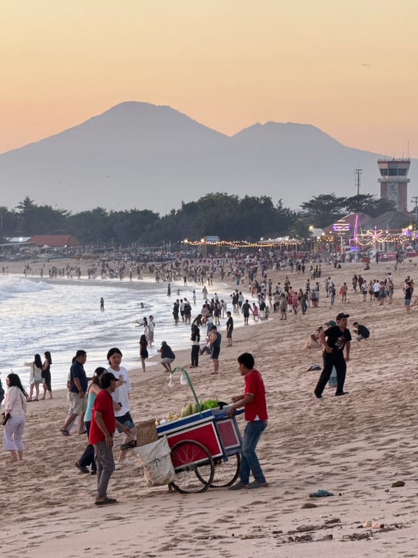 Tourists gather for sunset photography at Kuta Beach