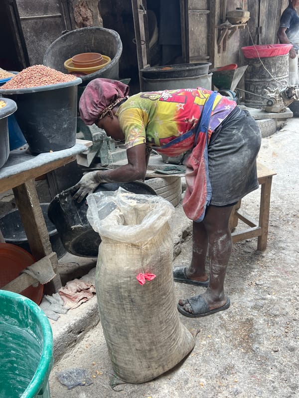 Market vendors conduct morning business in busy marketplace