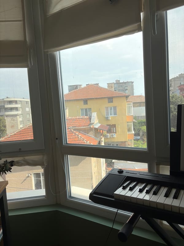 Home setup with a piano, record player, and goose mousepad
