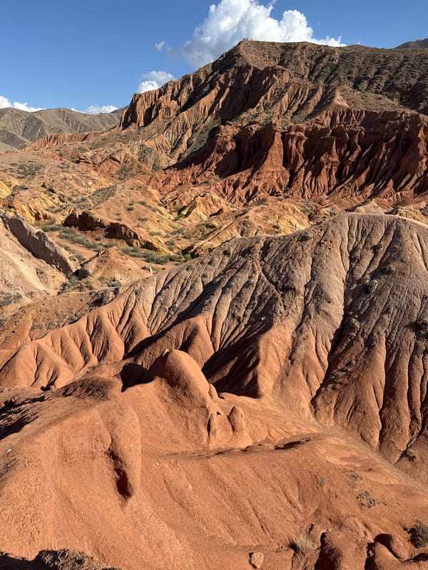 Hikers traverse rugged canyon near Tosor, Kyrgyzstan