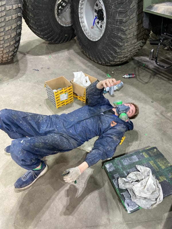 Worker in protective gear poses with spray equipment in Krasnoyarsk
