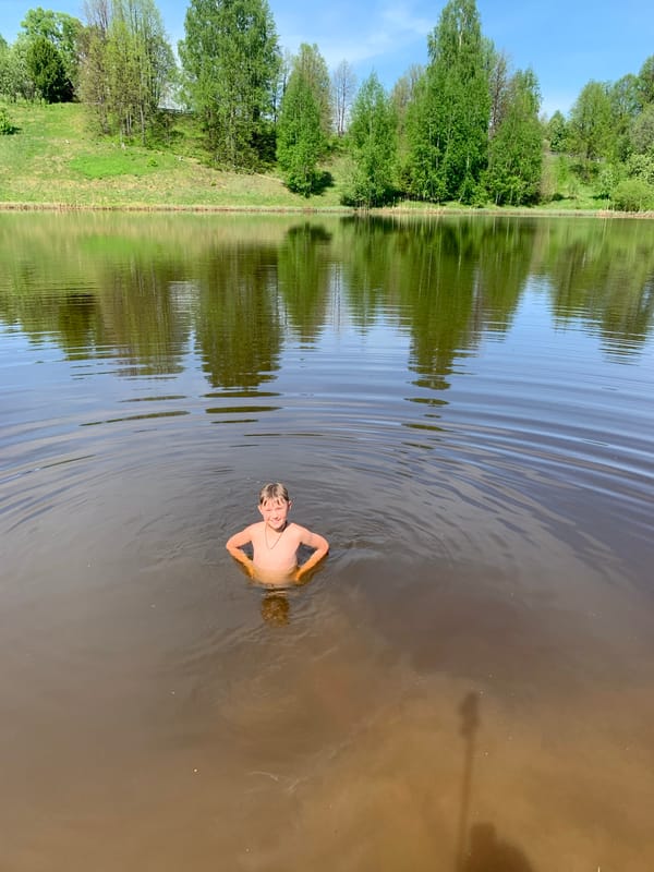 Swimmers enjoy murky waters in Zasechnyi, Russia