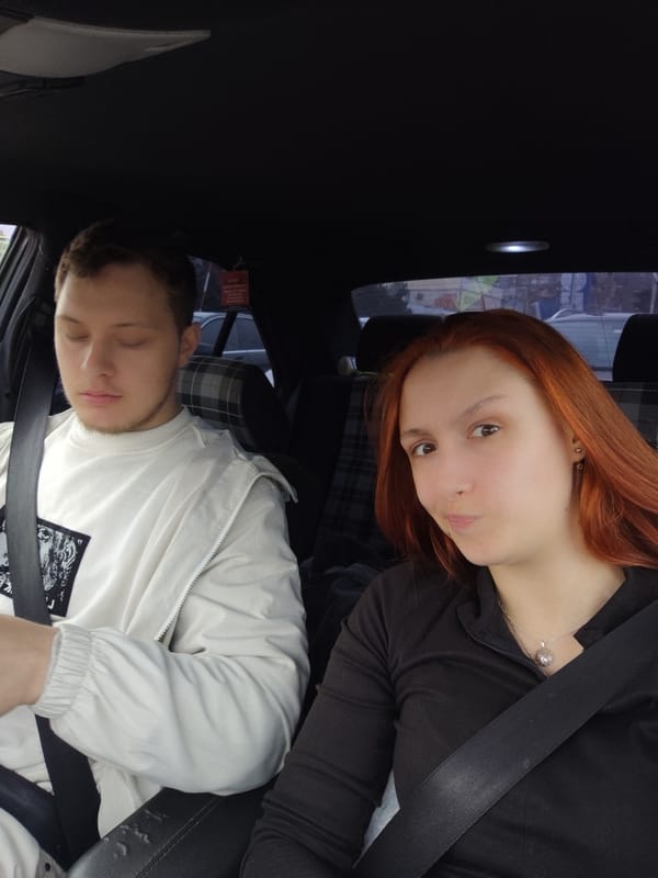 Two people wait in car outside Lidl supermarket, Vratsa