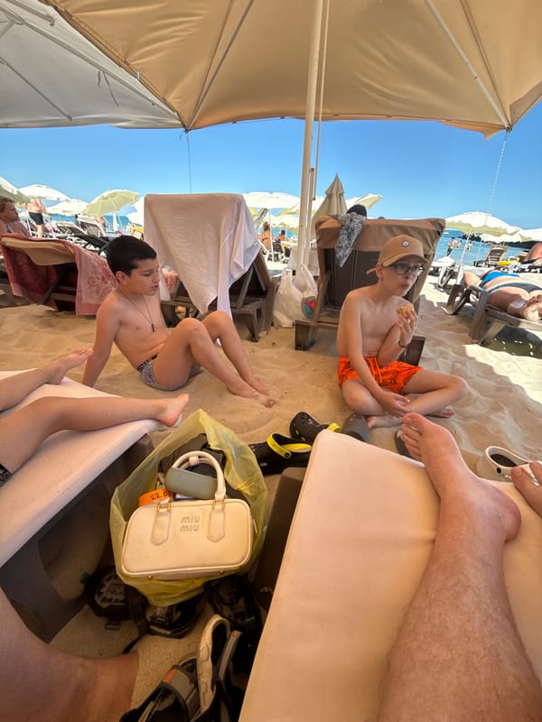 Lazy beach afternoon with kids, loungers, and tabletop items