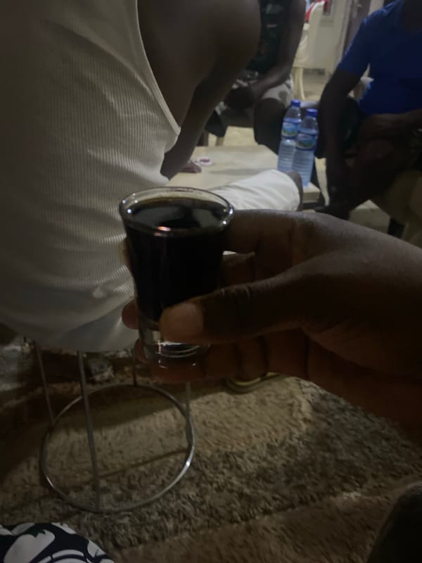 Social gathering with drinks and card games in Nigeria