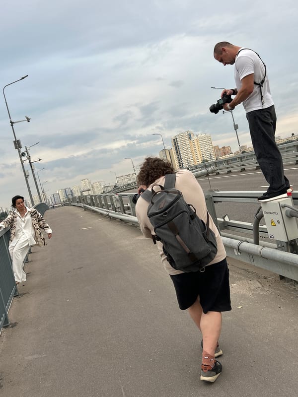 Group photographs a busy river from an urban bridge
