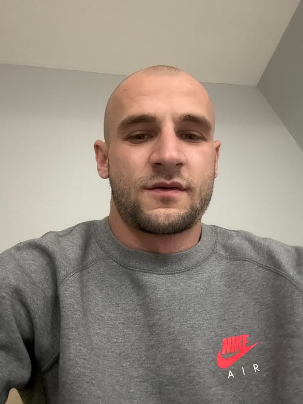 Man in Nike sweatshirt photographed indoors in Sofia
