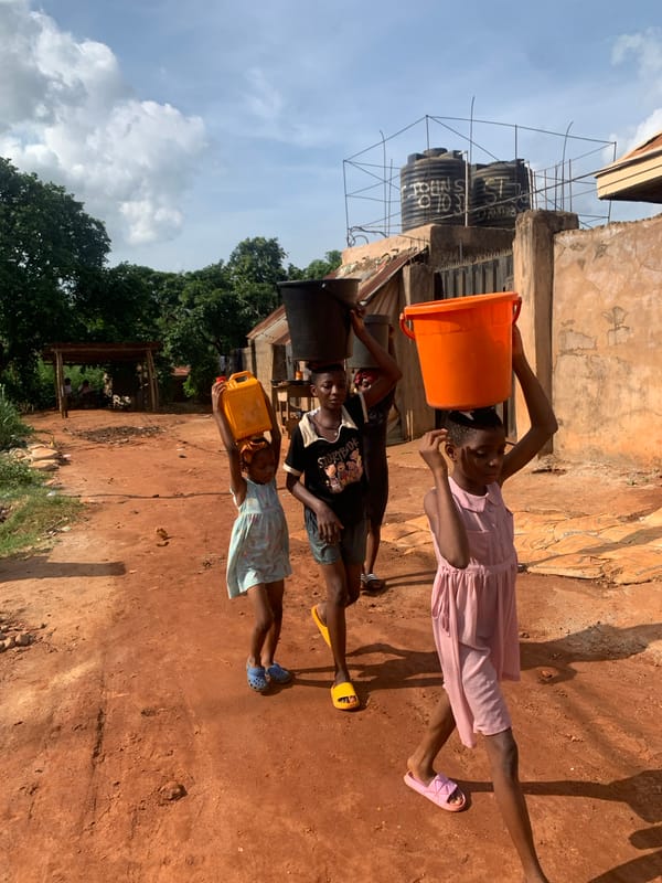 Children carry water containers in Ukwu-Abwa, Nigeria