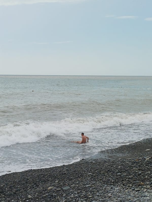 Quiet day on Sochi's pebble beach under overcast skies