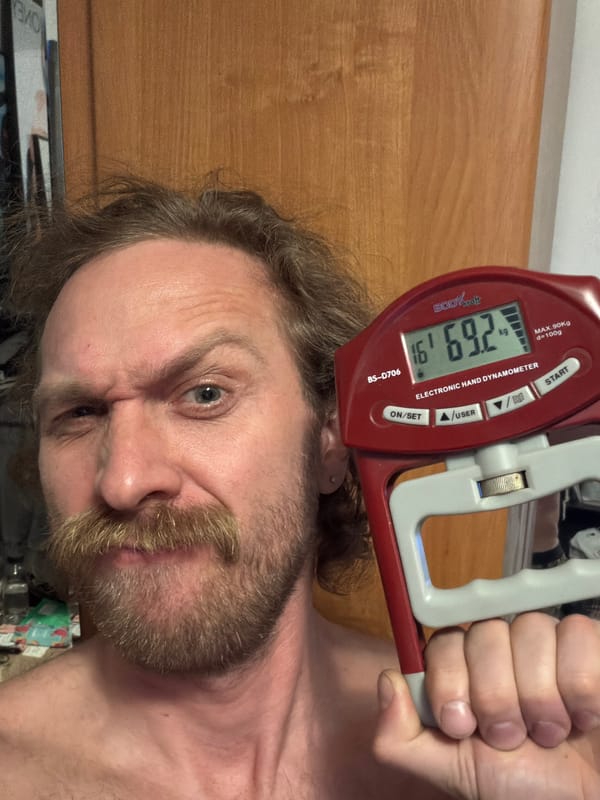 Person tests grip strength device in Saint Petersburg selfie