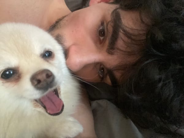 Person takes selfie with small white dog in Sofia