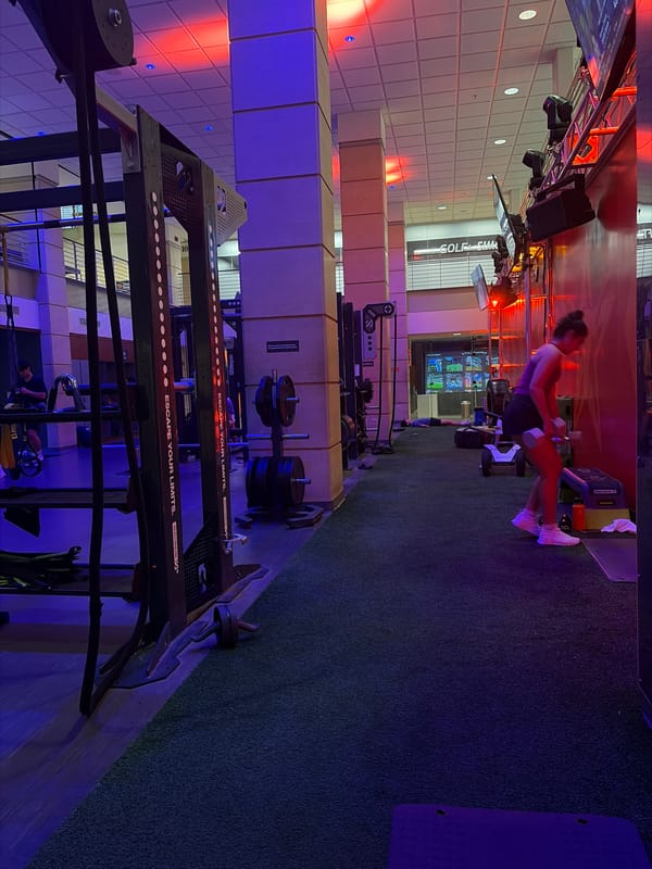 Woman exercises with weights at Austin gym late evening