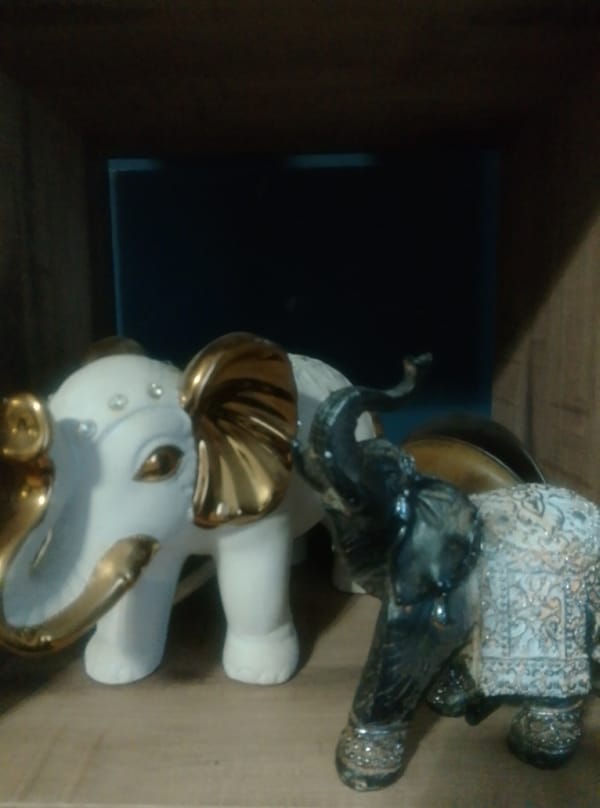 Eclectic shelf of figurines, plush toys, and holiday decorations