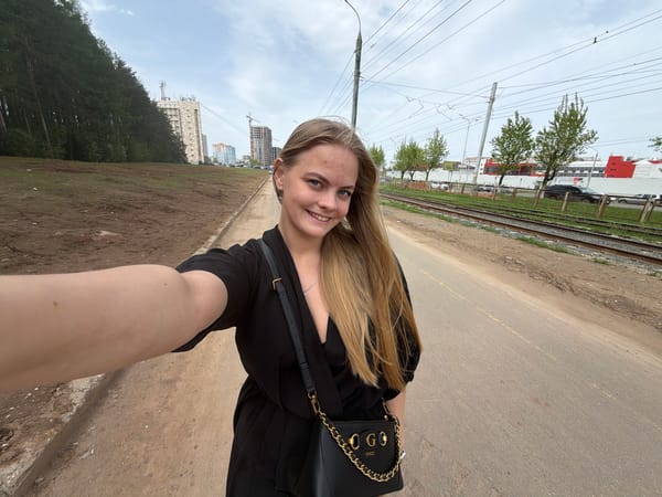 Woman takes selfies in sunny Izhevsk street