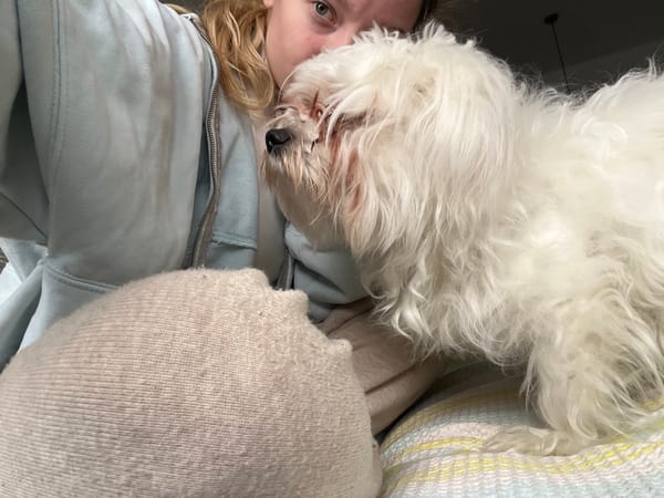 Woman poses with small white dog in Varna selfies