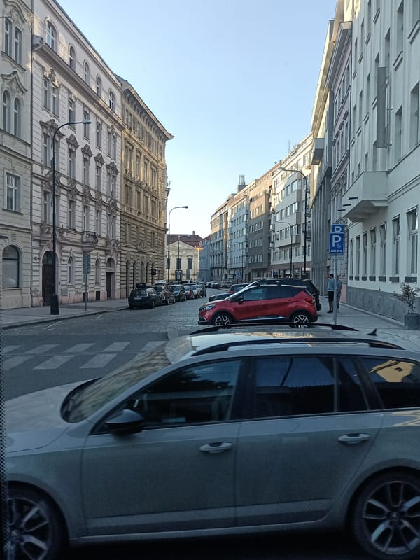 Prague's historic streets and church facades in late afternoon light