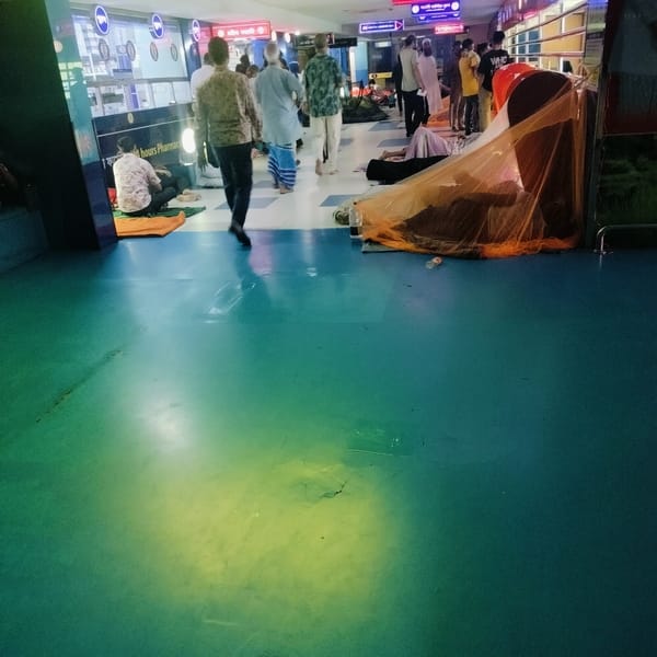 People Rest on Floors of Public Building in Dhaka