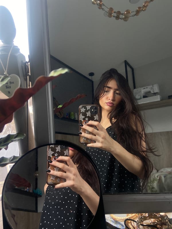 Young woman takes morning mirror selfies in London residence