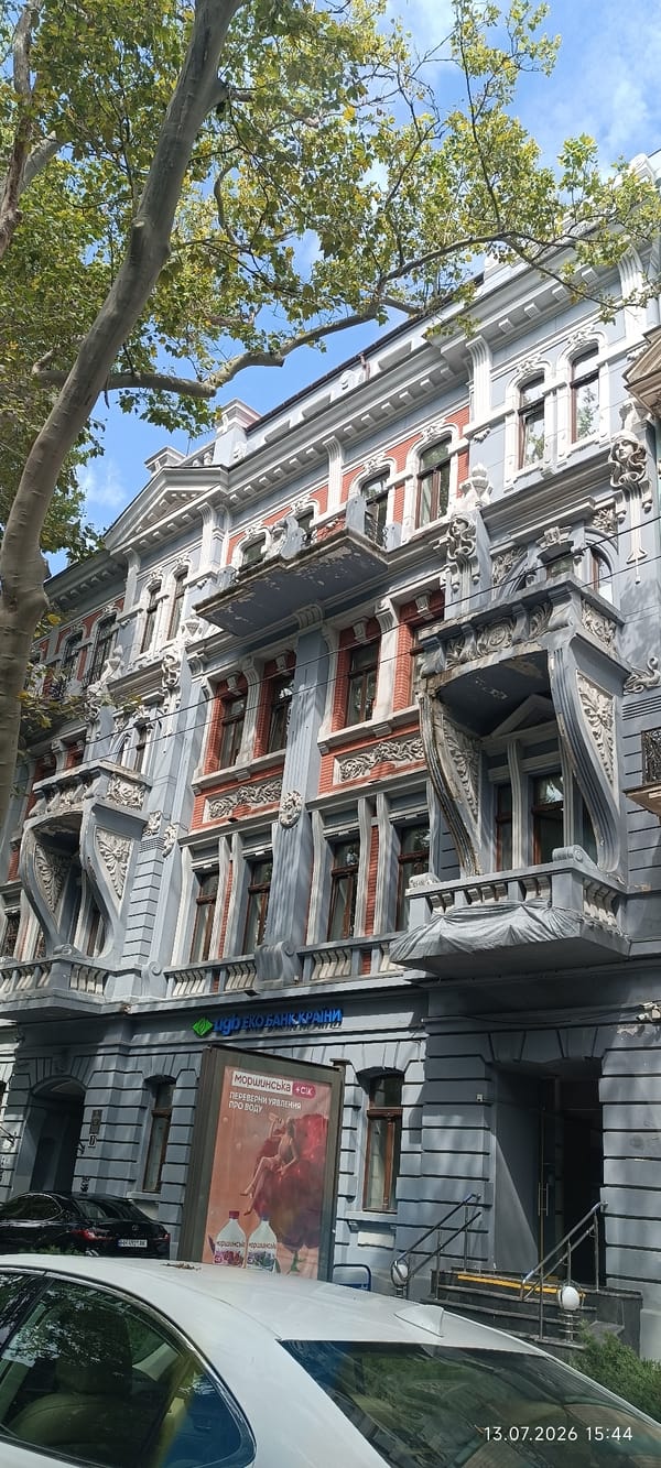 Ornate light blue building with decorative balconies in Odesa