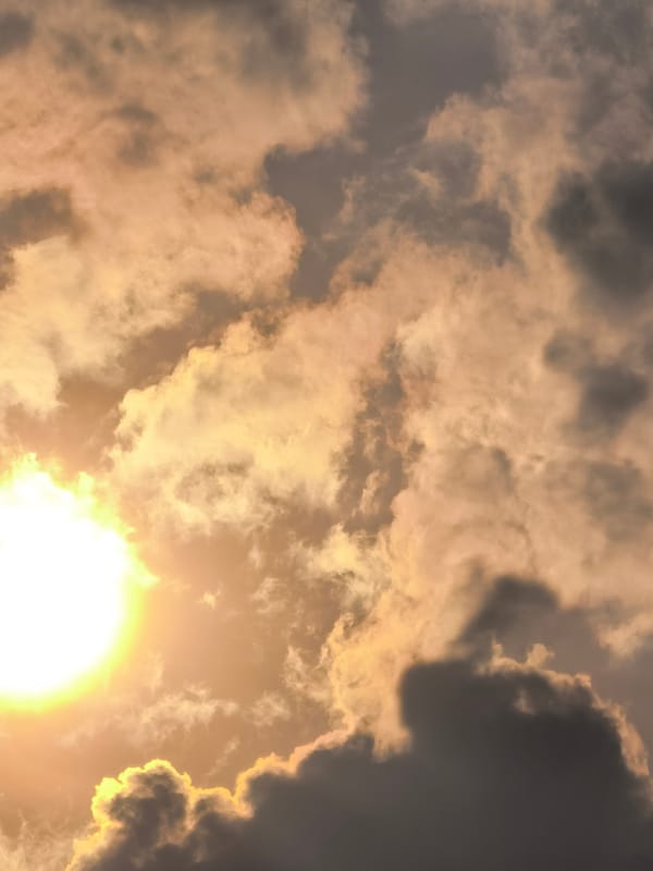 Sunlight breaks through dramatic cloud cover in layered sky shots
