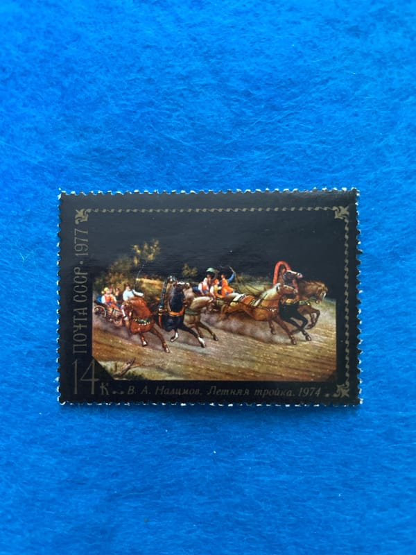 Stamp collection spread across blue felt, Perm, Russia