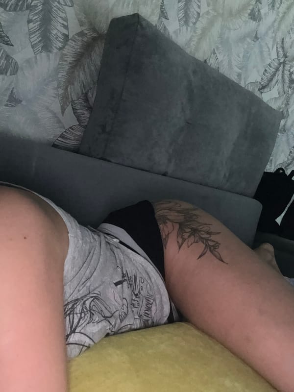 Person watches TV on sofa during evening in Russia