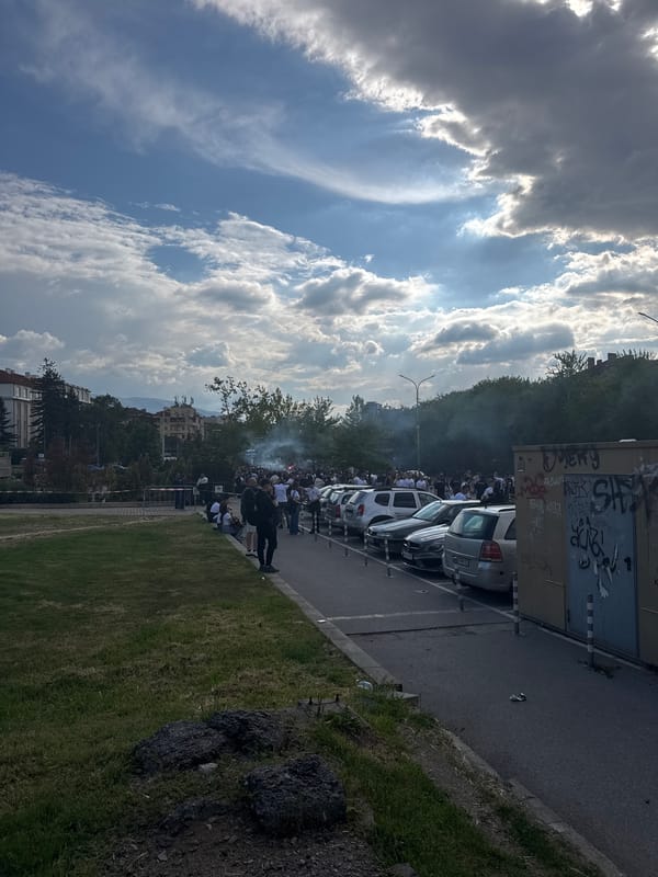 Crowd gathers on Sofia street, smoke visible