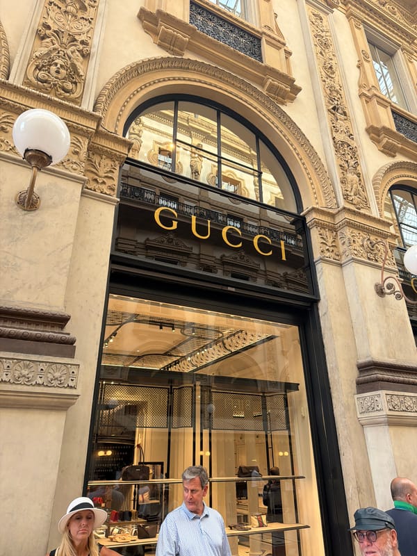 Tourist documents luxury shopping district in Milan's historic Galleria