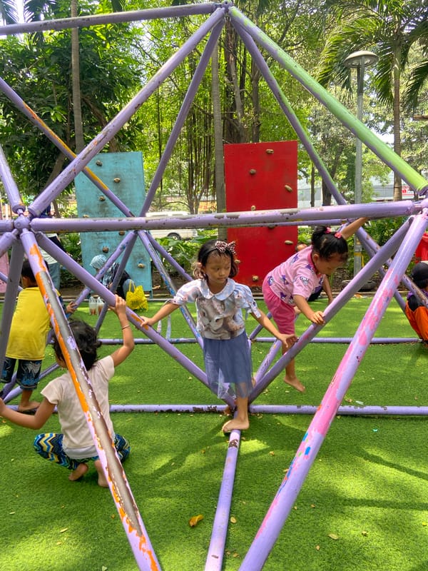 Children play at Surabaya playground, some in traditional costumes