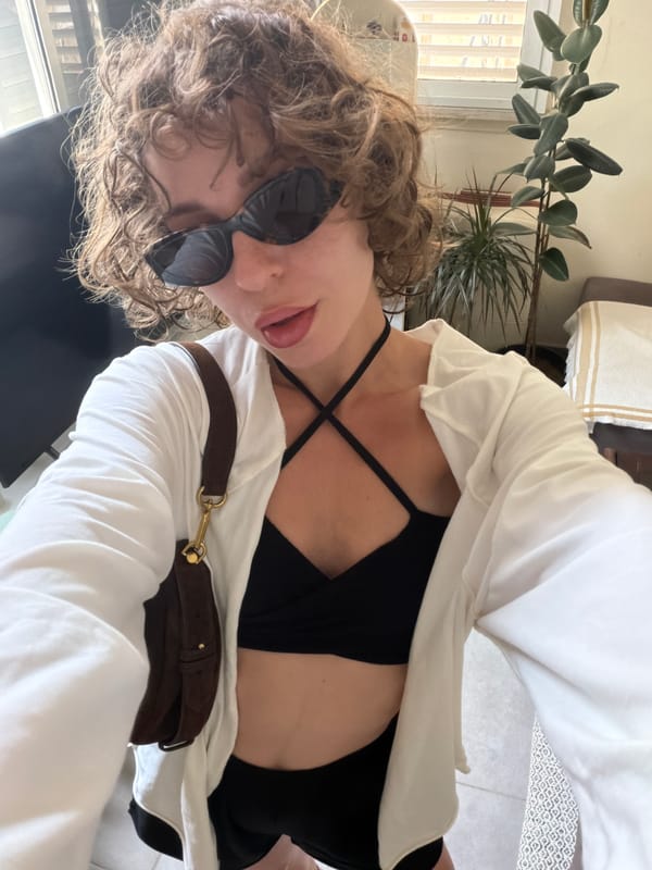 Indoor selfie moment in Tel Aviv with greenery in the background