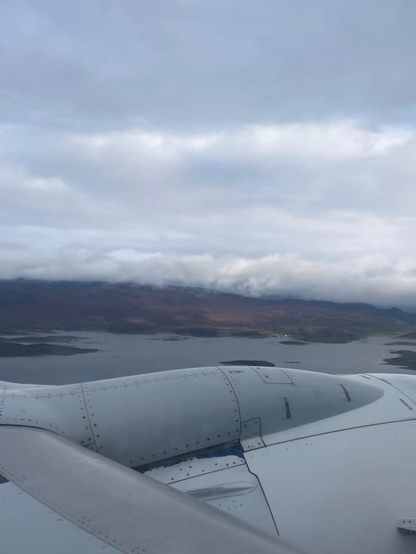 Airplane wing and engine viewed from passenger window over Argentina