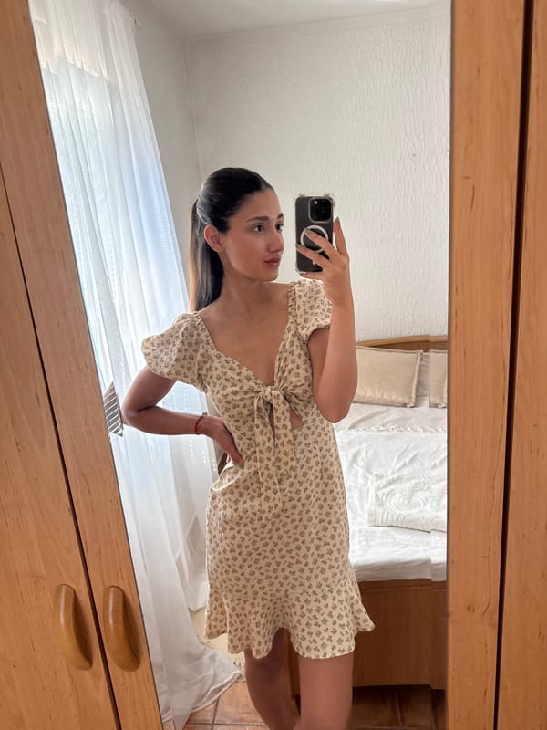 Woman takes selfies in floral dress in Montenegro village