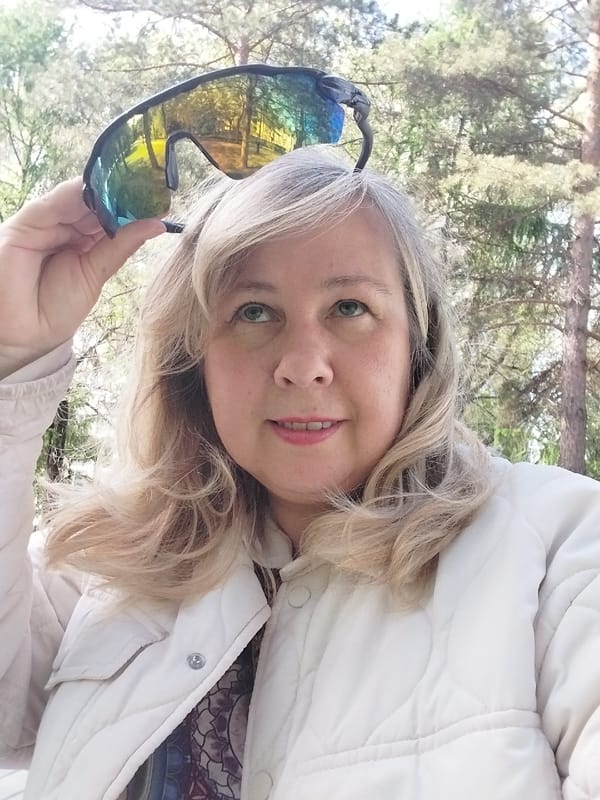 Woman photographs spring park visit in Orenburg, Russia