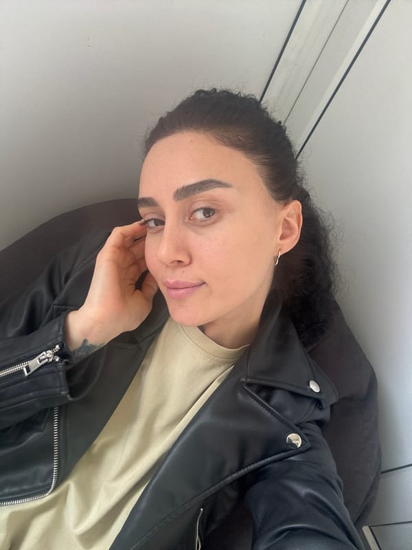 Woman photographs herself during office session in Tbilisi
