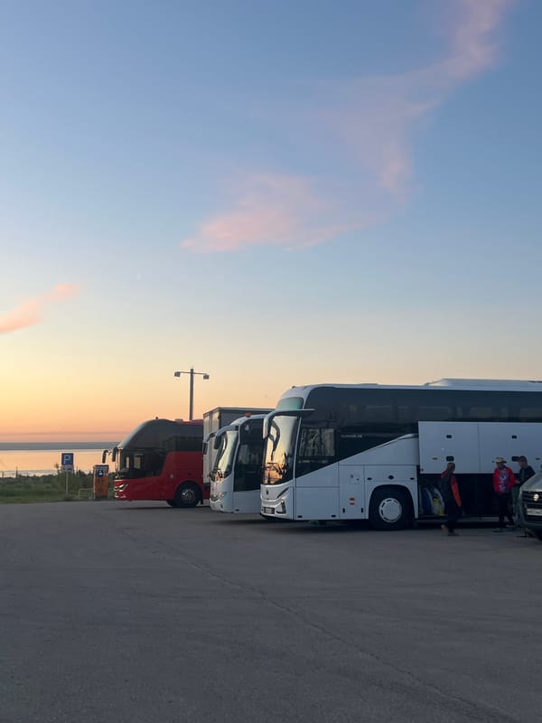 Buses park at Khvalynsk rest stop during sunset